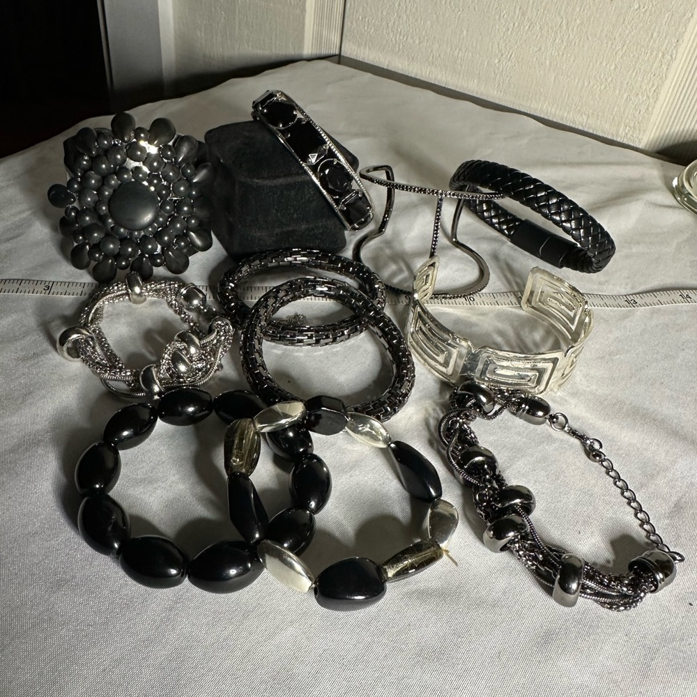 Eleven black and silvertone theme bracelets
